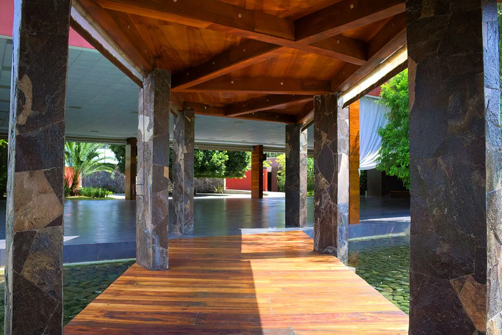 Pasillo de madera entre columnas de piedra